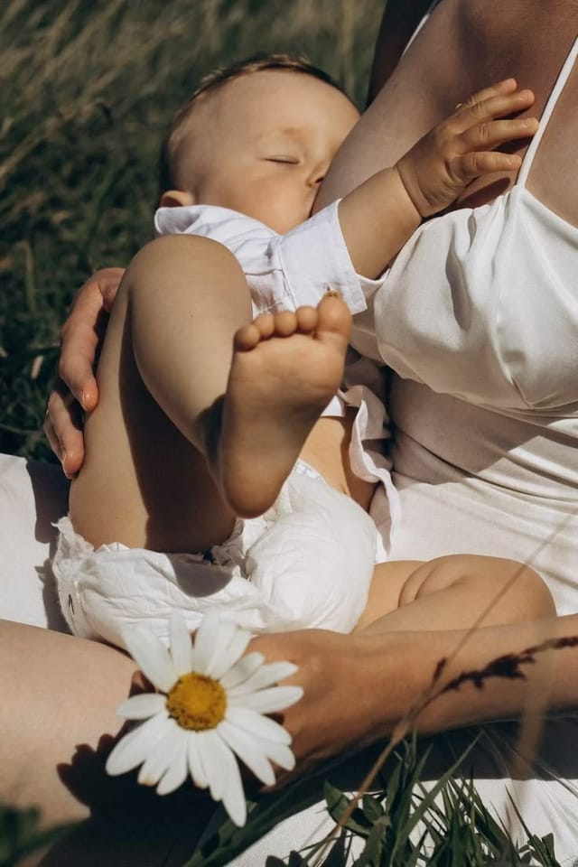 Lactation consultant supporting a breastfeeding mother